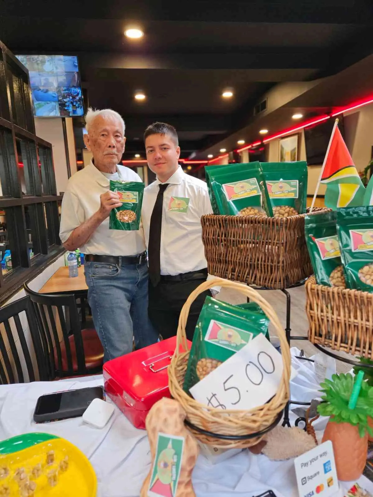 Grandad and Braedon at a Grandad's Nuts pop-up with green packs