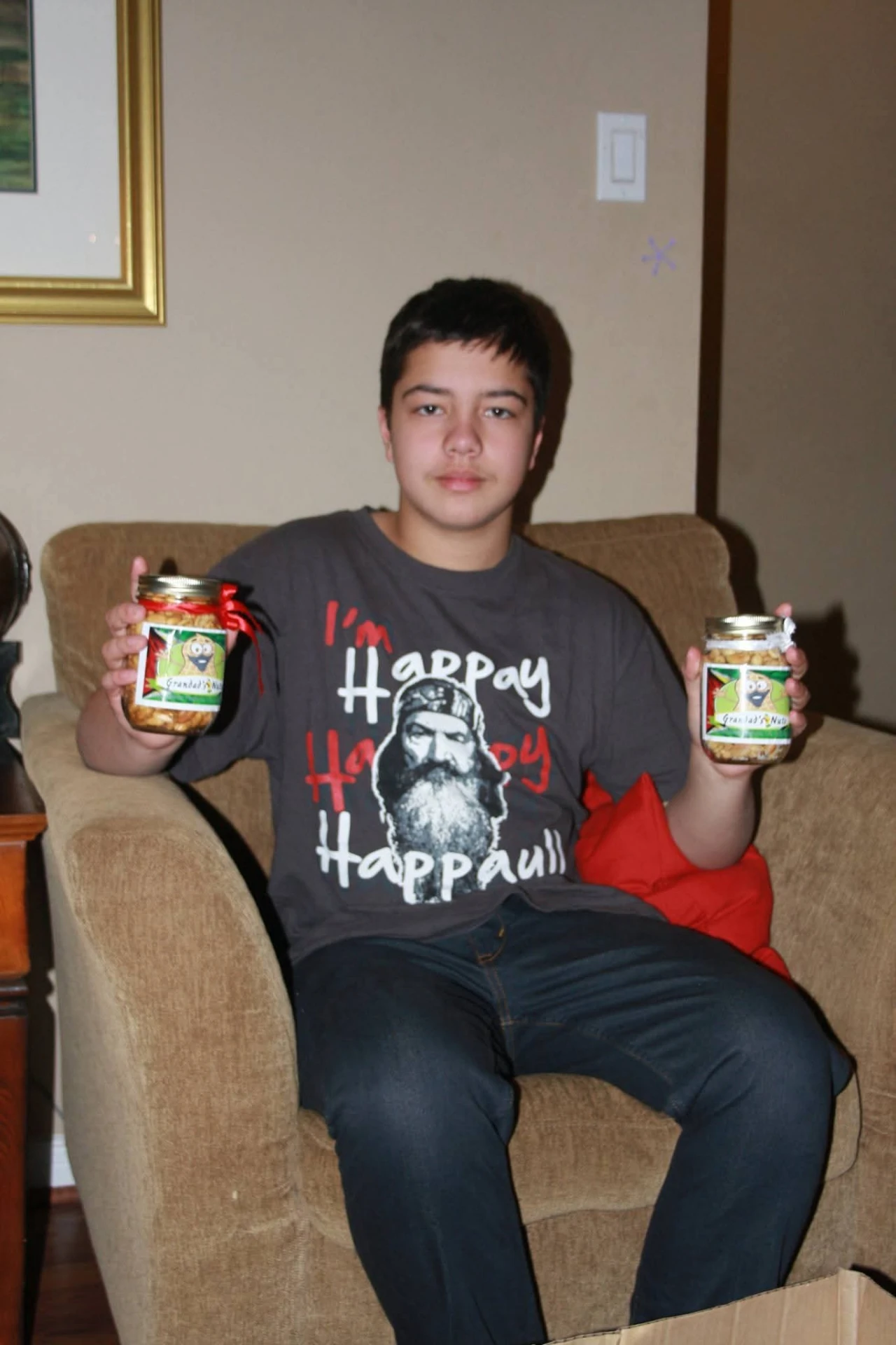 Braedon holding two jars of Grandad's Nuts